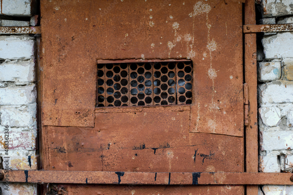 A fragment of an old rusty door A fragment of an old rusty door