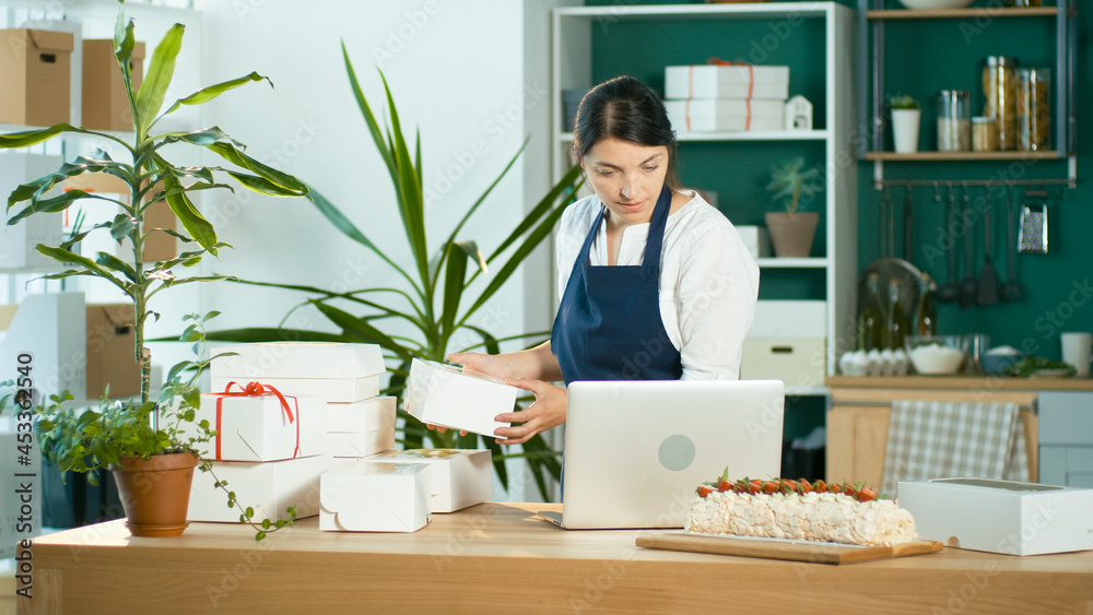 Successful Female Small Business Owner Prepares a Customer Order. Successful Female Small Business Owner Prepares a Customer Order.