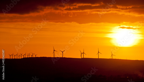 Windfarm during sunset on the skyline