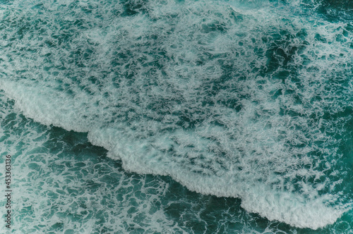 Detail of the ocean with waves and white bubbles