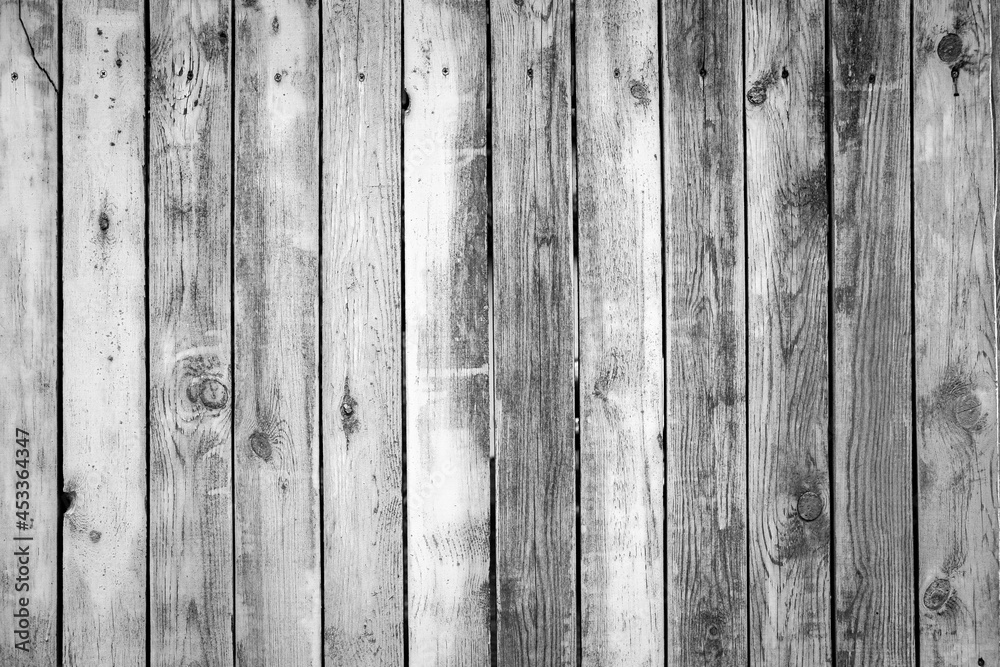 Naklejka premium Wooden texture background. Black and white beautiful old wooden wall or fence close up. Grey backdrop for design. Vertical wooden boards. Close up, copy space