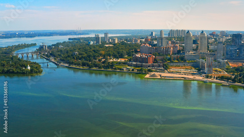 Aerial view over beautiful center Dnepr city with a wide river  green trees  buildings - in summer.. Beautiful downtown  aerial photography.