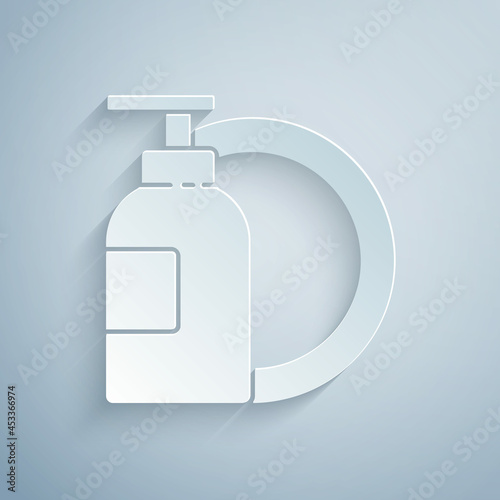 Paper cut Dishwashing liquid bottle and plate icon isolated on grey background. Liquid detergent for washing dishes. Paper art style. Vector Illustration