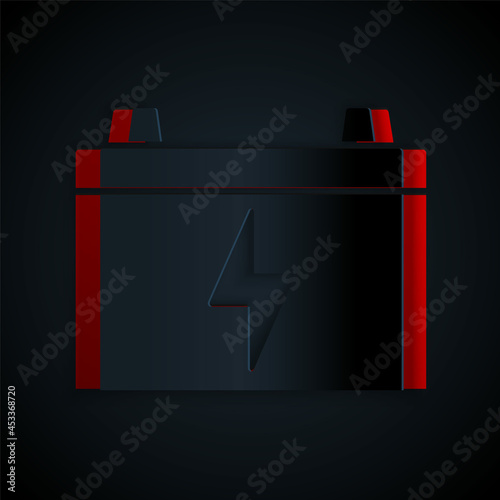 Paper cut Car battery icon isolated on black background. Accumulator battery energy power and electricity accumulator battery. Paper art style. Vector