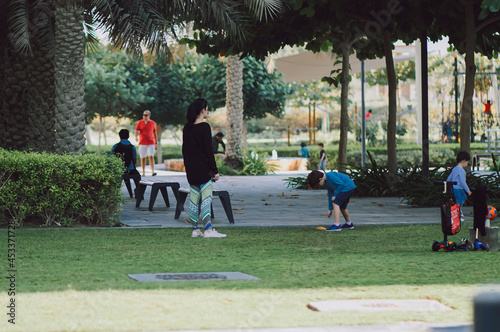 Family and Children Playing in the Park Outdoor on Green Grass