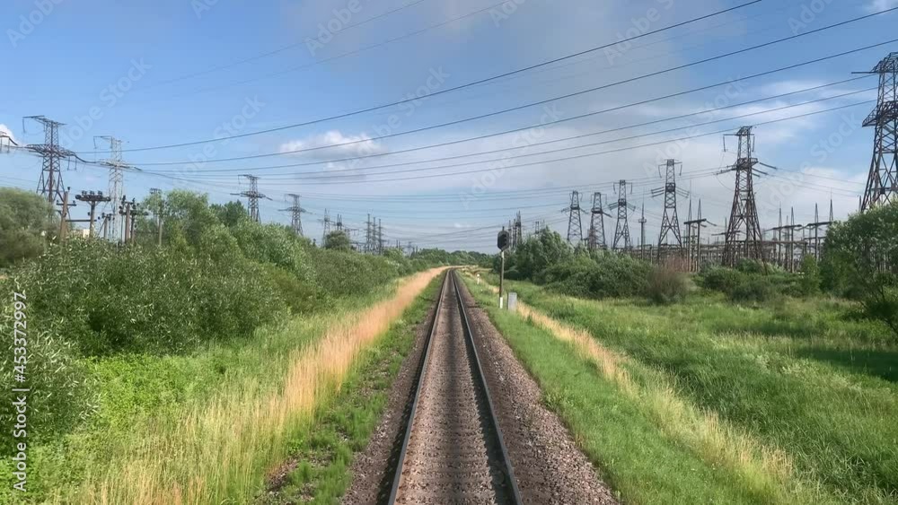 blured side view of high-speed turning end back of train on landscape of beautiful nature wild field and mountains forest on clean sunny day in summer. Transport, travel, railway, communication blured side view of high-speed turning end back of train on landscape of beautiful nature wild field and mountains forest on clean sunny day in summer. Transport, travel, railway, communication