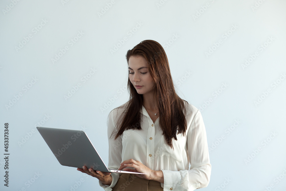 young beautiful girl in office clothes works on a laptop young beautiful girl in office clothes works on a laptop