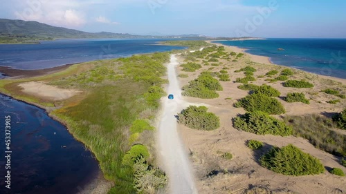 Road on a land strip between Korission Lake coastal lagoon and Ionian Sea on Corfu Island, Greece, 4k video photo