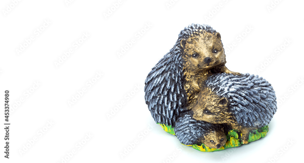 artificial family of hedgehogs concrete garden figure for landscaping and backyard decoration, isolated stone object on white background, nobody.