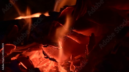 Close-up of a burning campfire, night bonfire, logs, plywood and fabriv are on fire, gust sparks fly, slo-mo HD video