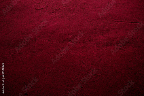 Crimson colored wall background with textures of different shades of crimson red photo