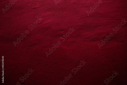Crimson colored wall background with textures of different shades of crimson red