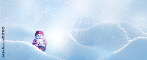 Christmas card. Santa Claus in snowdrifts in the rays of light. Winter snowy background. Banner format.