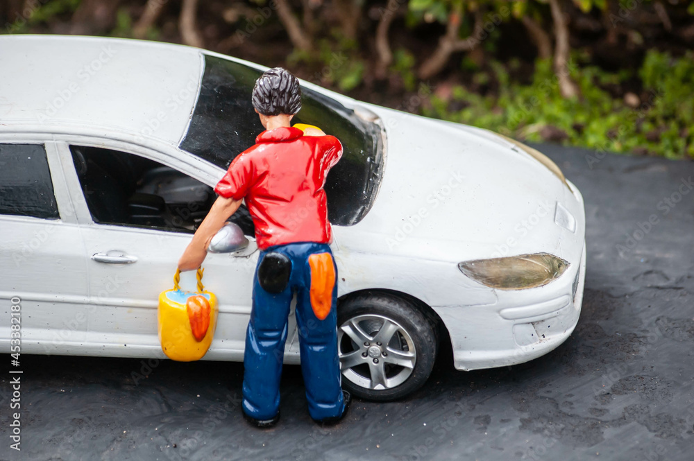 Closeup of tiny model man washing a white car Closeup of tiny model man washing a white car