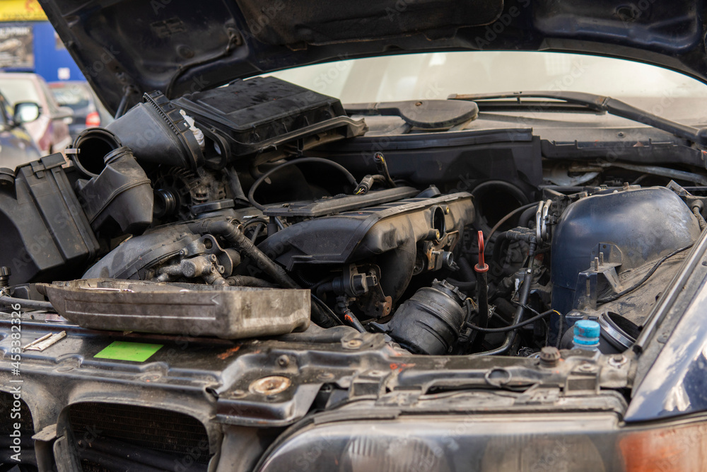 scatter old car parts in the engine compartment after engine repair. scatter old car parts in the engine compartment after engine repair.
