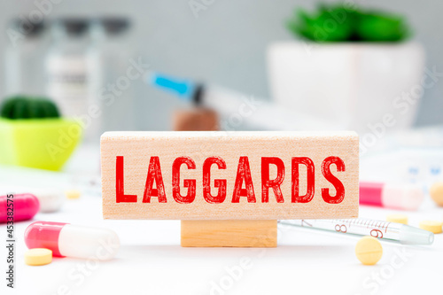 word Laggards on wooden block, medical concept photo