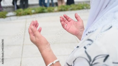 Bosnian woman praying in graveyard in Memorial centre Srebrenica. Mass funeral of war victims in Potočari. Burial ceremony  of genocide victims in 1995.    photo