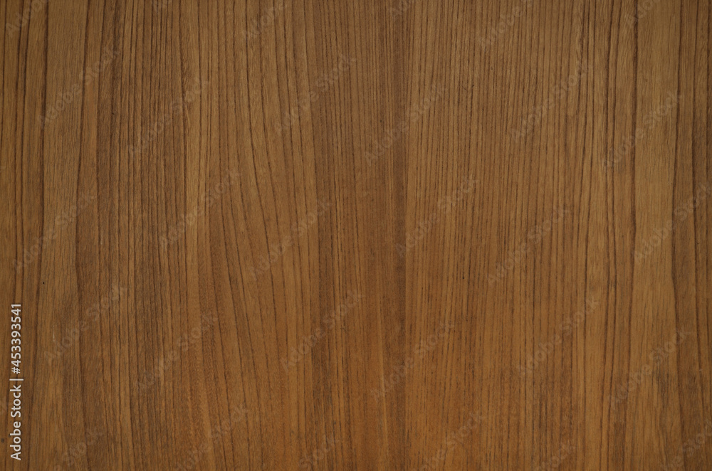 Vertical grained wood board texture background. Brown wood grain veneer backdrop.