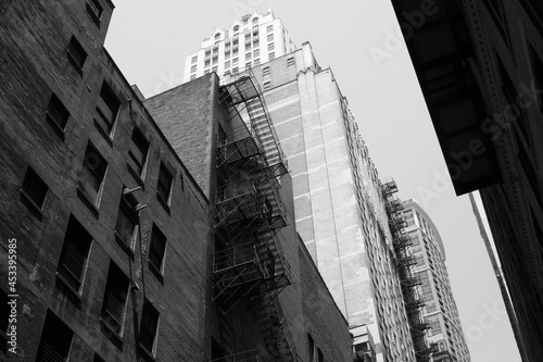 city skyscrapers with a fire escape in black and white