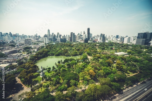 Public park and high-rise buildings cityscape in metropolis city center . Green environment city and downtown business district in panoramic view .