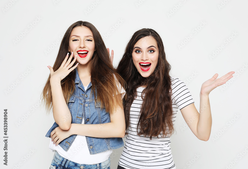 Two young girl friends having fun. Both making surprised faces. Two young girl friends having fun. Both making surprised faces.