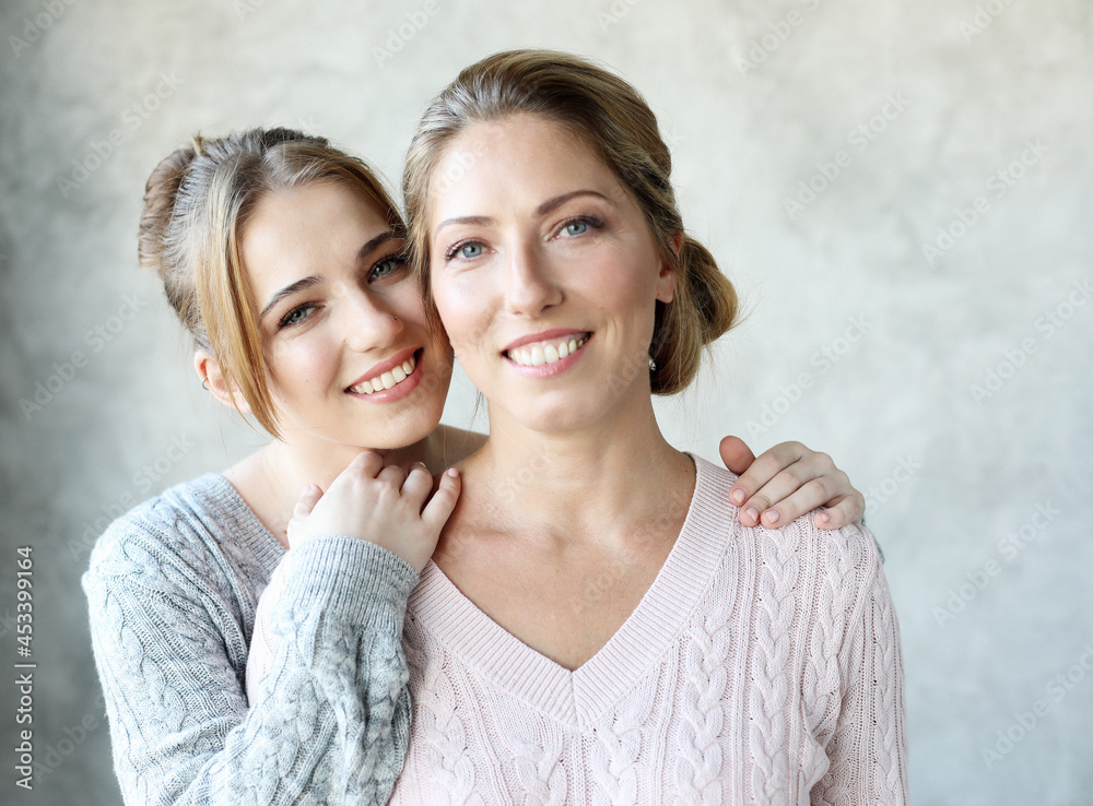 Happy young woman and her mother at home, happy family