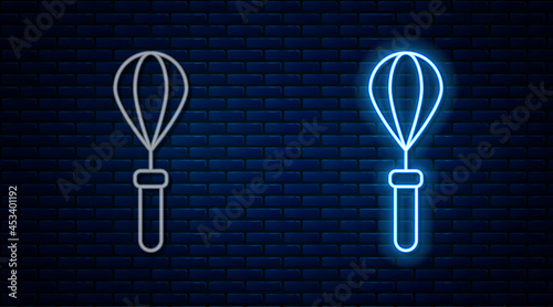 Glowing neon line Kitchen whisk icon isolated on brick wall background. Cooking utensil, egg beater. Cutlery sign. Food mix symbol. Vector