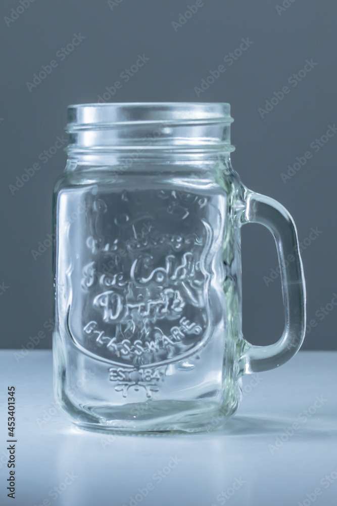 An empty jar with a grey background An empty jar with a grey background