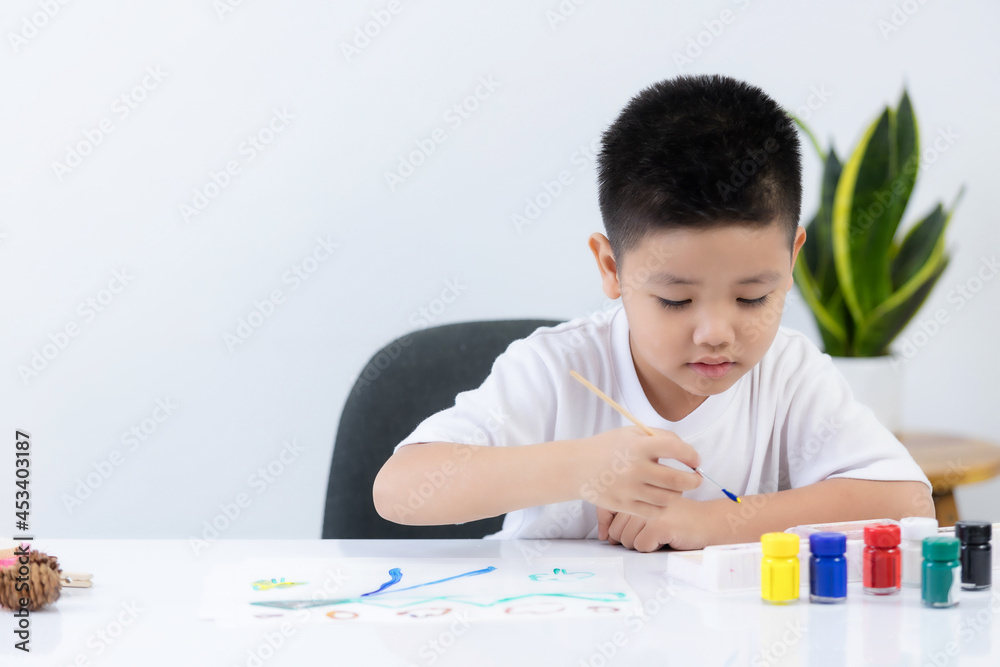 Happy little Asian kid at the table draw with water color Learning and education of kid. Happy little Asian kid at the table draw with water color Learning and education of kid.