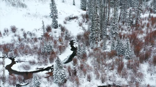 Aerial over snow frosted, winter landscapes.