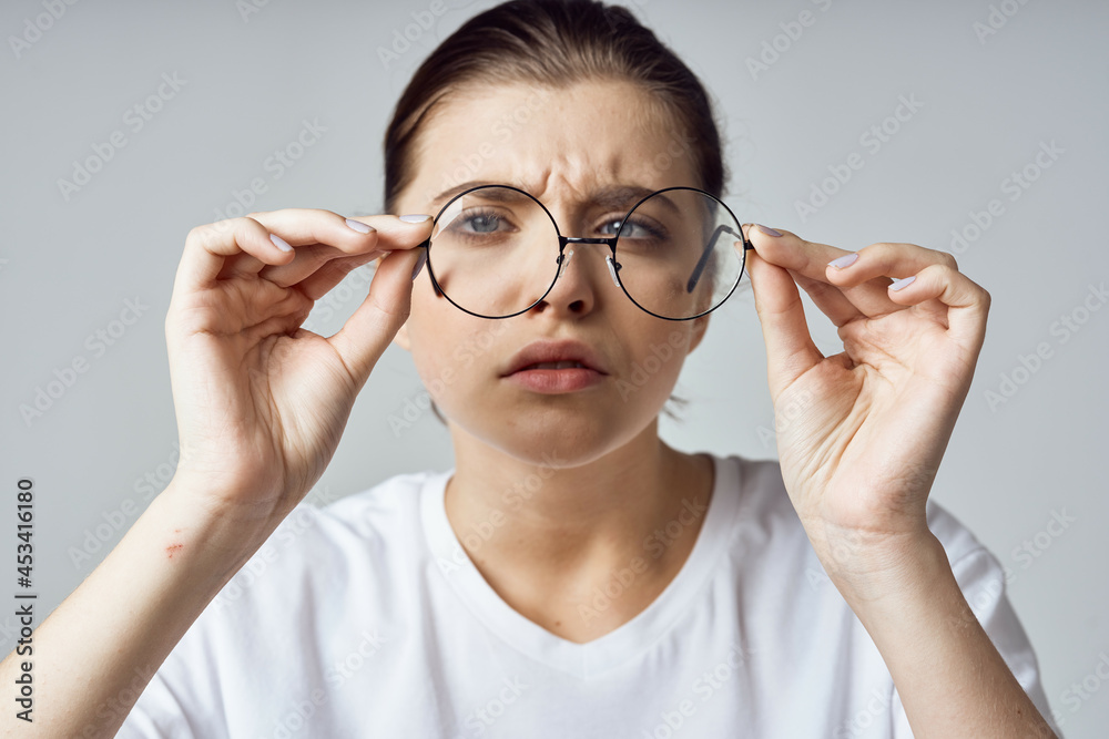 woman in white t-shirt glasses poor eyesight close-up woman in white t-shirt glasses poor eyesight close-up