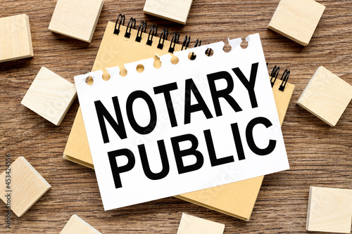 Notary Public. notebook and wood blocks on wood background