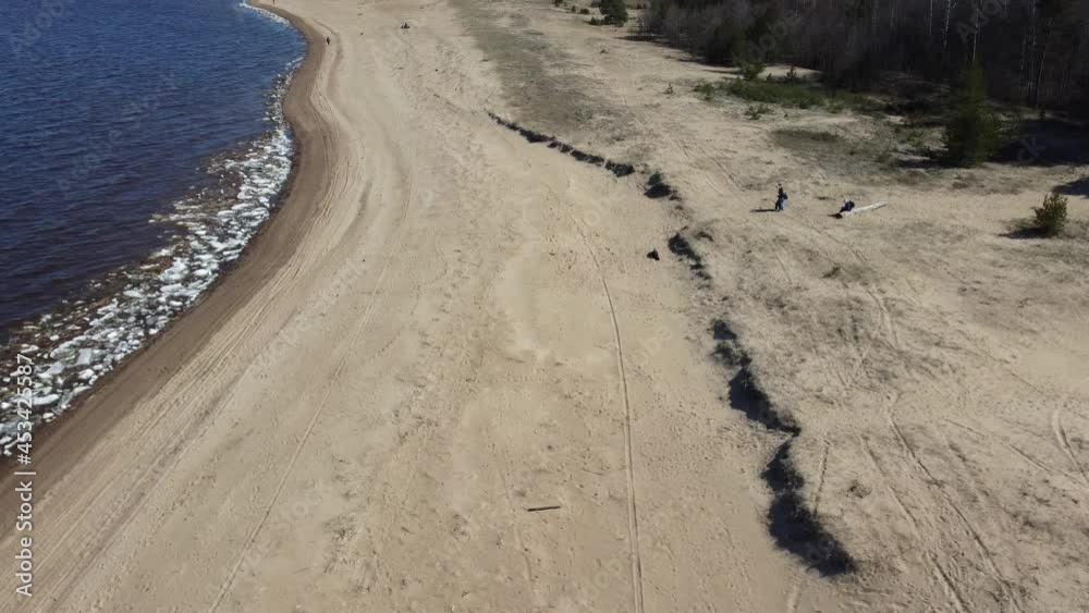 Drone flight over the beach in early spring on a sunny morning. Gulf of Finland beach, St. Petersburg, Russia Drone flight over the beach in early spring on a sunny morning. Gulf of Finland beach, St. Petersburg, Russia