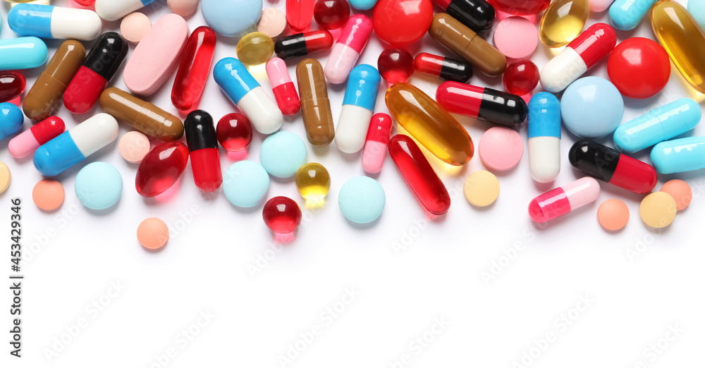 Lots of different colorful pills isolated on white, top view Lots of different colorful pills isolated on white, top view