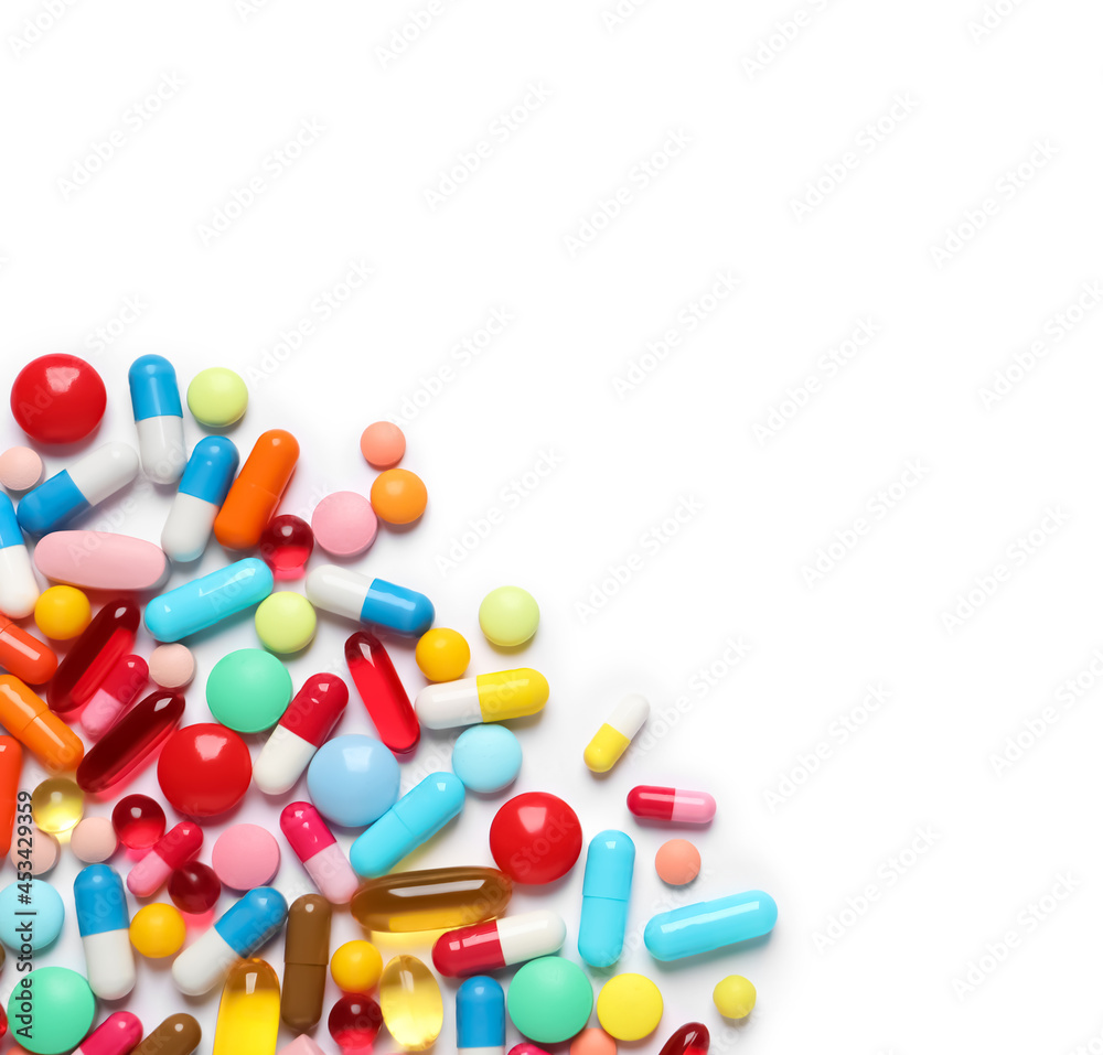 Lots of different colorful pills isolated on white, top view Lots of different colorful pills isolated on white, top view