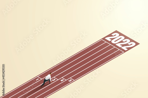 Businessman ready in starting position towards goals