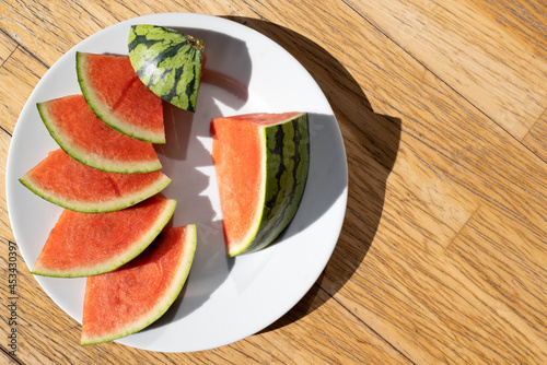 Slices of a red juicy watermelon on a plate 