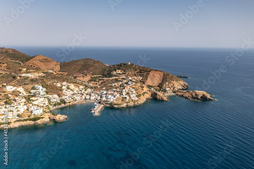 panoramic view of the sea and mountains and ships on turquoise water filmed from a drone