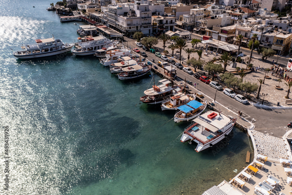 panoramic view of the sea and mountains and ships on turquoise water filmed from a drone