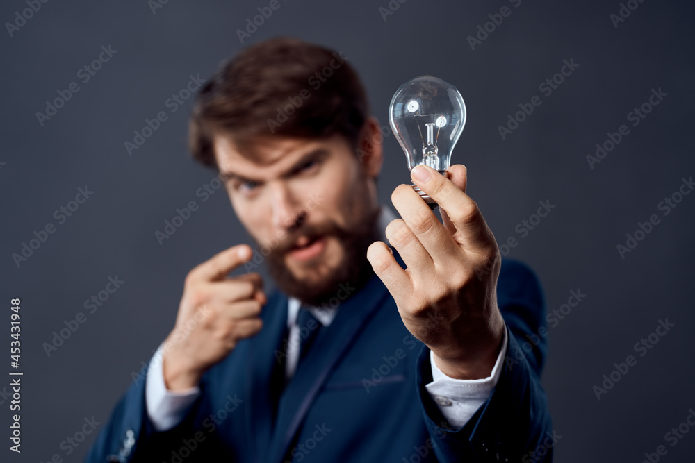 business man in a suit with a lamp in his hands creativity business man in a suit with a lamp in his hands creativity