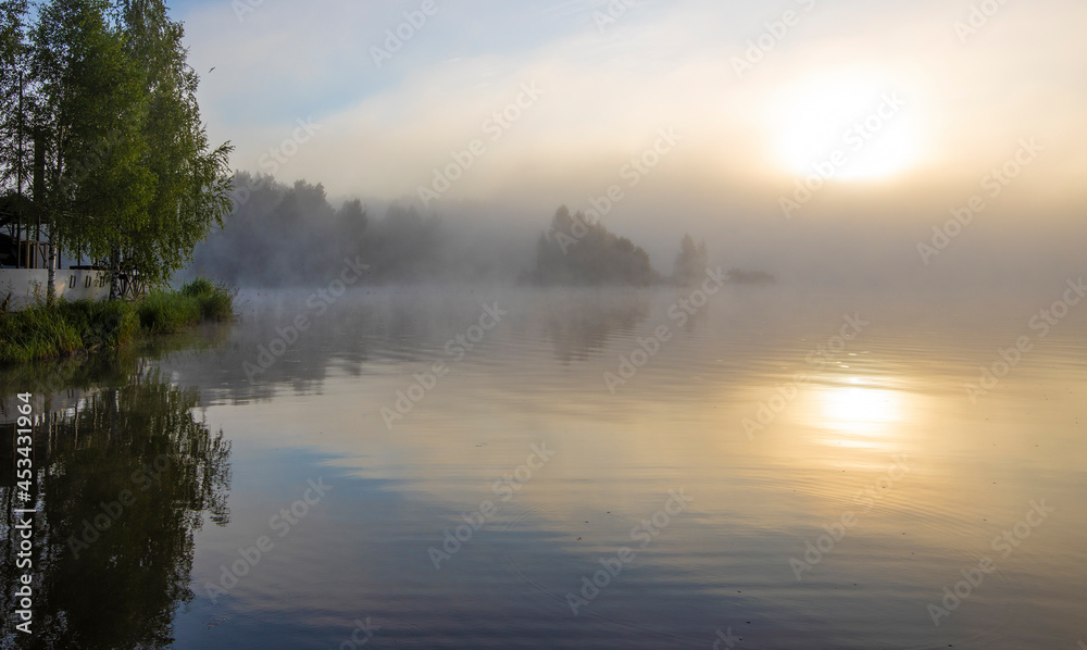 Fototapeta premium Early morning. Fog on the river. Beautiful sunrise in the summer by the river.River on an early summer morning at dawn.