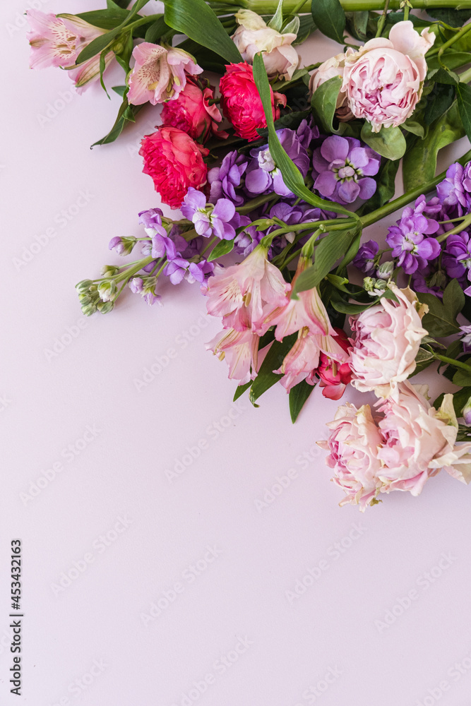 Fototapeta Aesthetic background with colourful rose flowers on pink background. Beautiful floral composition