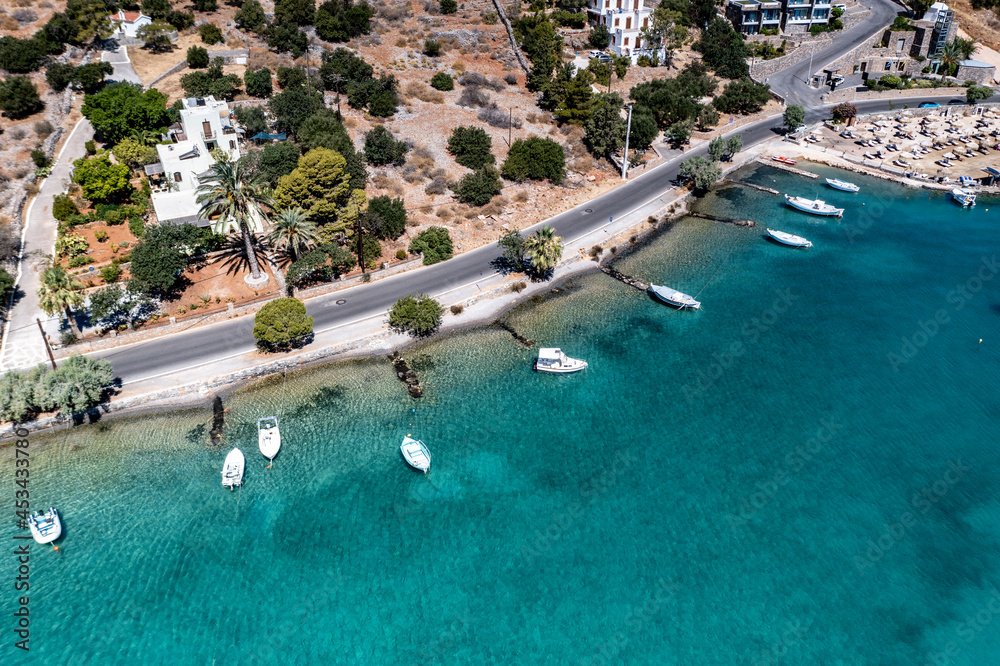 panoramic view of the sea and mountains and ships on turquoise water filmed from a drone