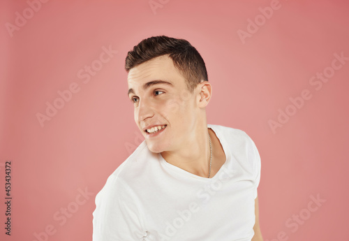 smiling man in white t-shirt cropped view pink background attractive view © SHOTPRIME STUDIO