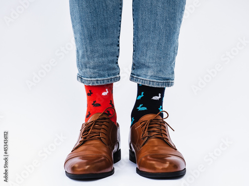 Men's legs, trendy shoes and bright socks. Close-up. Style, beauty and elegance concept