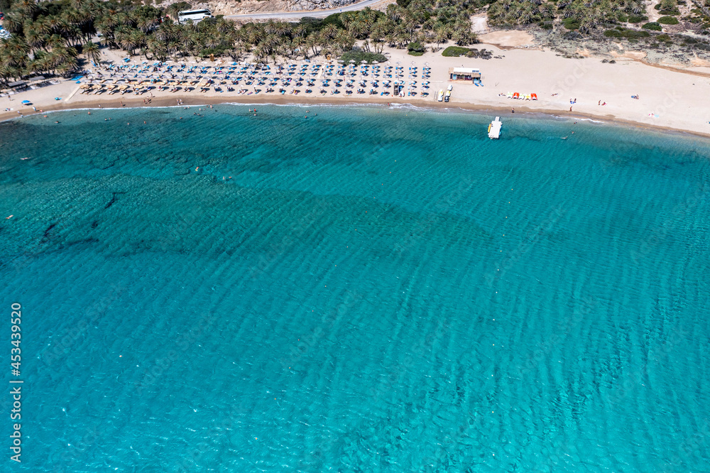 panoramic view of the sea and mountains and a boat on turquoise water filmed from a drone 