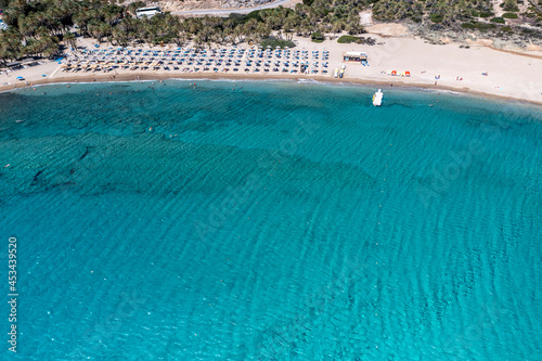panoramic view of the sea and mountains and a boat on turquoise water filmed from a drone 