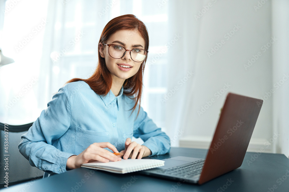 woman sitting at a table in front of a laptop learning disorder fatigue
