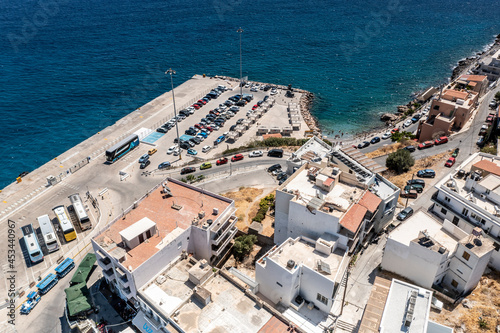 panoramic view of the Cretan city with white houses on the embankment near the sea filmed from a drone 