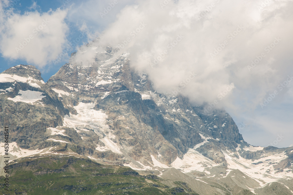 View of high massif of Monte Cervino (Matterhorn) covered by cloud in Aosta Valley, Italian alps, Europe